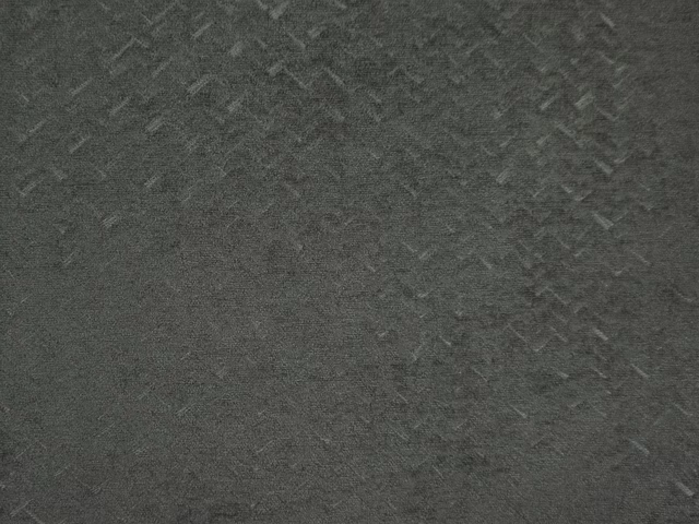 Deep charcoal-grey chenille with subtle angular marks and a softly brushed surface