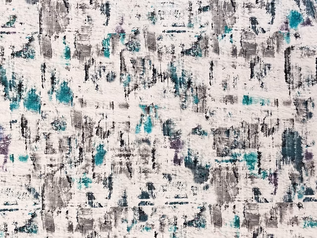 Ivory velvet with distressed charcoal marks and vivid teal painterly accents