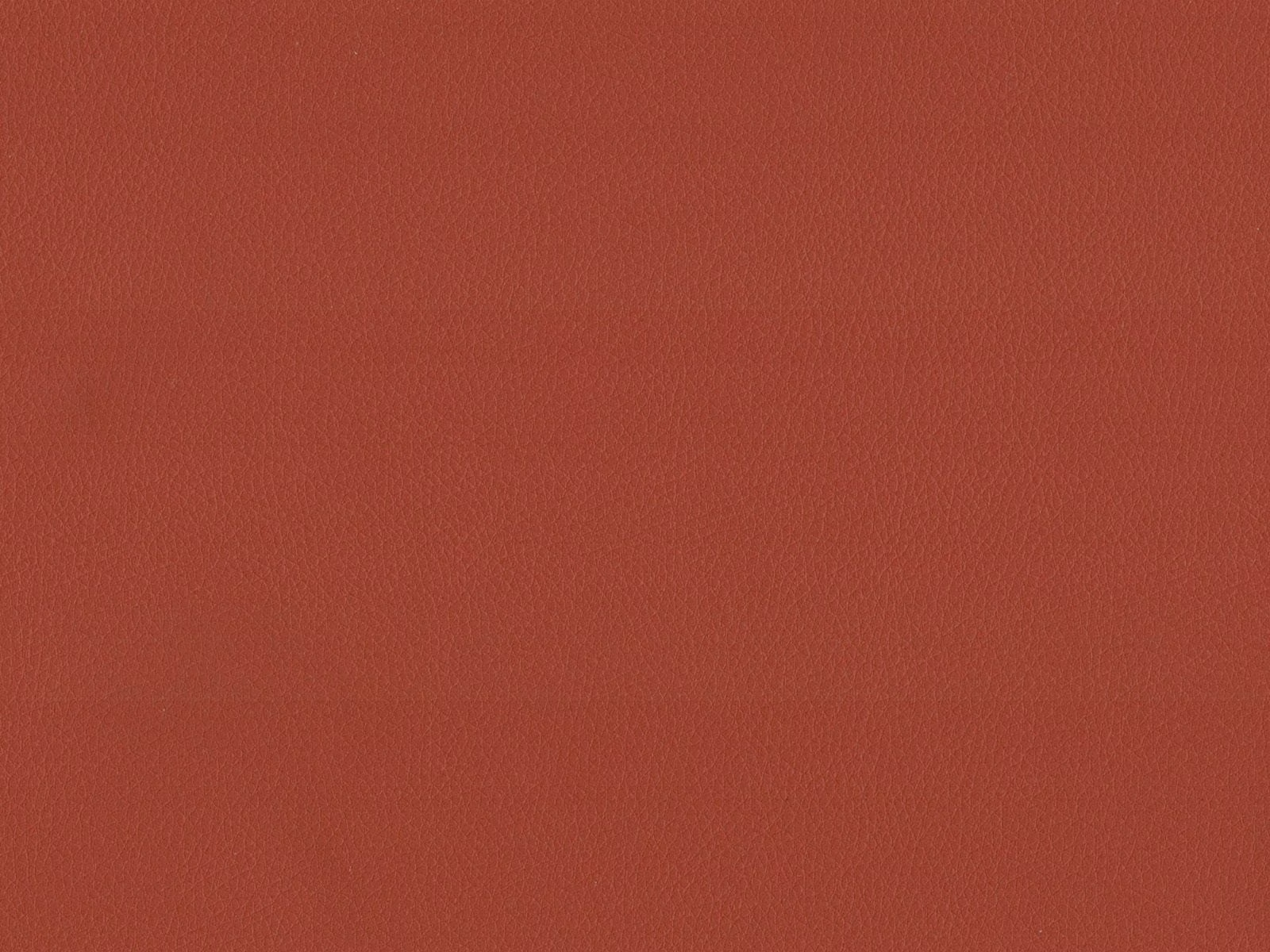 Muted brick-terracotta faux leather with a fine, lightly pebbled grain