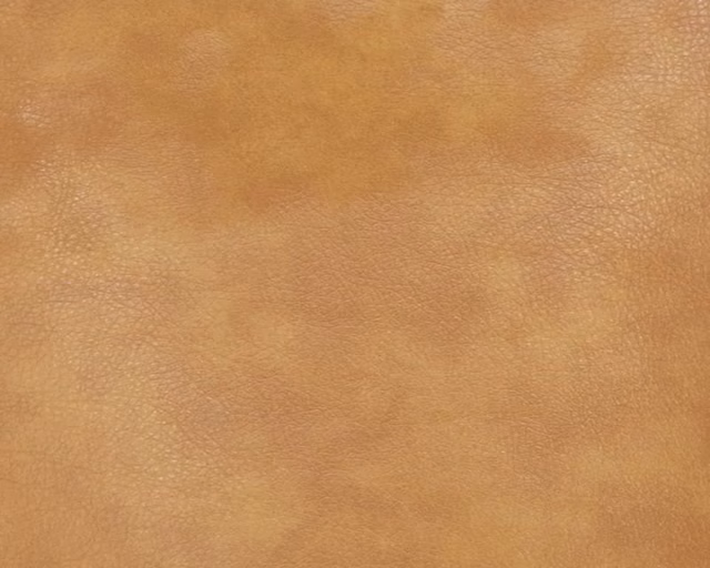 Warm caramel faux leather with subtle mottling and fine pebbled grain
