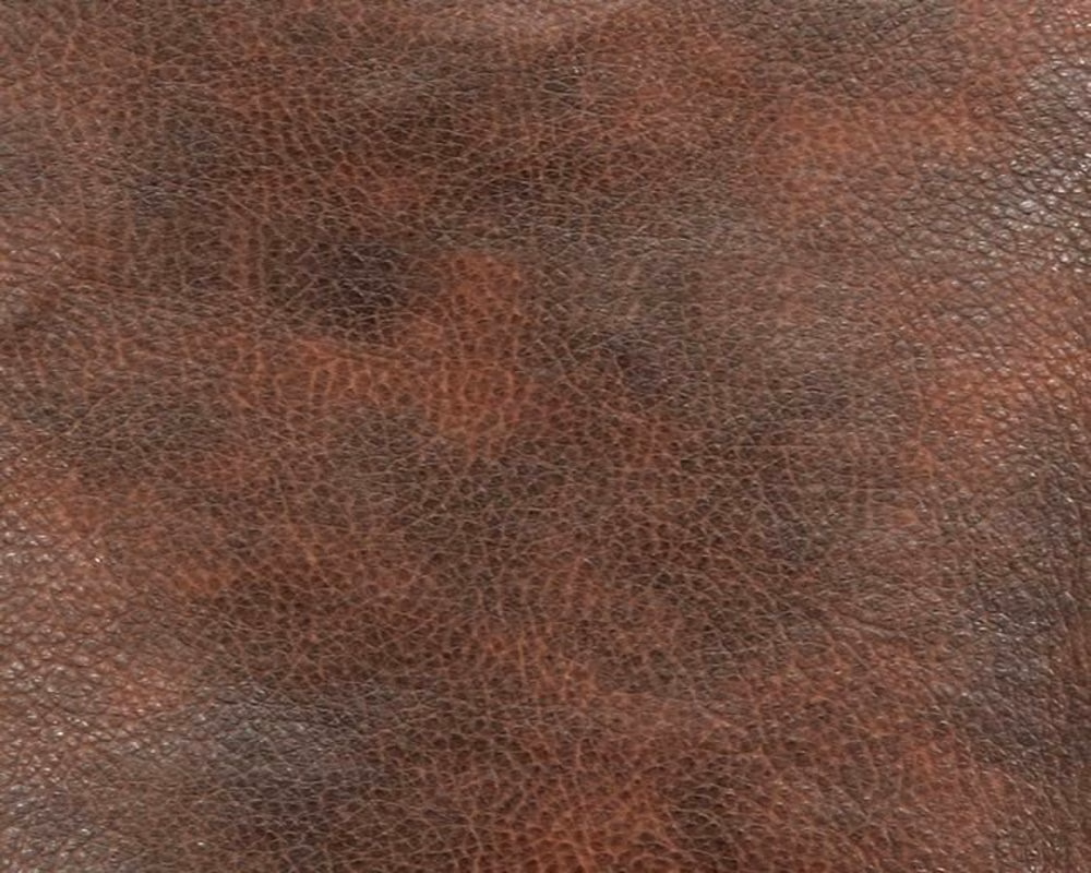 Russet and deep brown faux leather with a fine pebbled, mottled surface