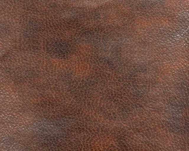 Russet and deep brown faux leather with a fine pebbled, mottled surface