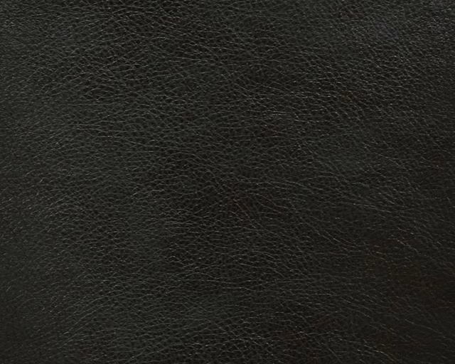 Close-up of charcoal-black faux leather with a fine irregular pebbled grain
