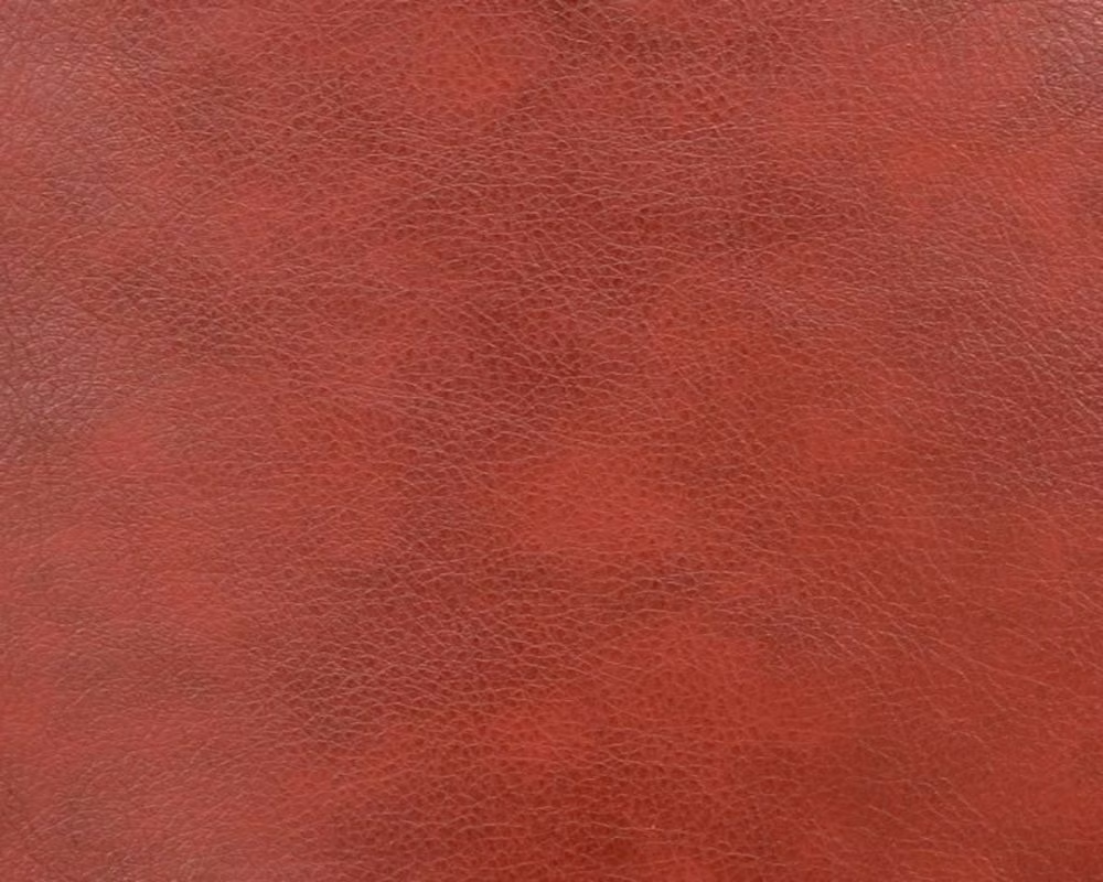 Deep brick-red faux leather with a fine, softly pebbled surface
