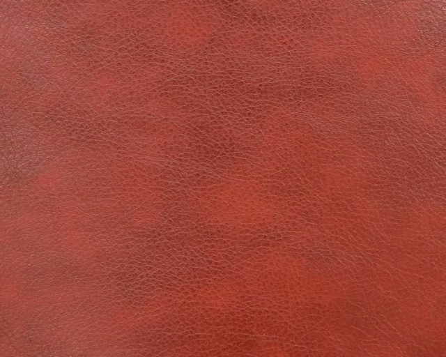 Deep brick-red faux leather with a fine, softly pebbled surface