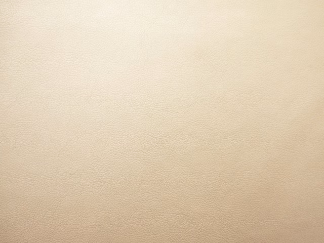 Warm ivory-beige faux leather with a subtle, fine-grained surface