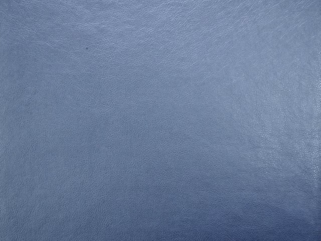 Muted slate-blue faux leather with softly mottled grain and subtle sheen
