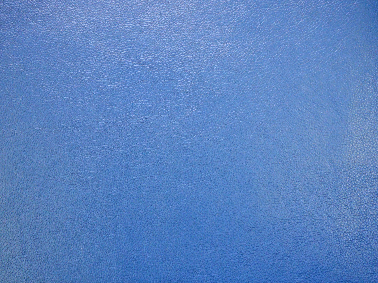Close-up of cool mid-blue faux leather with a fine pebbled grain