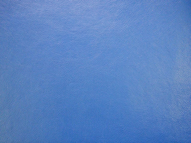 Close-up of cool mid-blue faux leather with a fine pebbled grain
