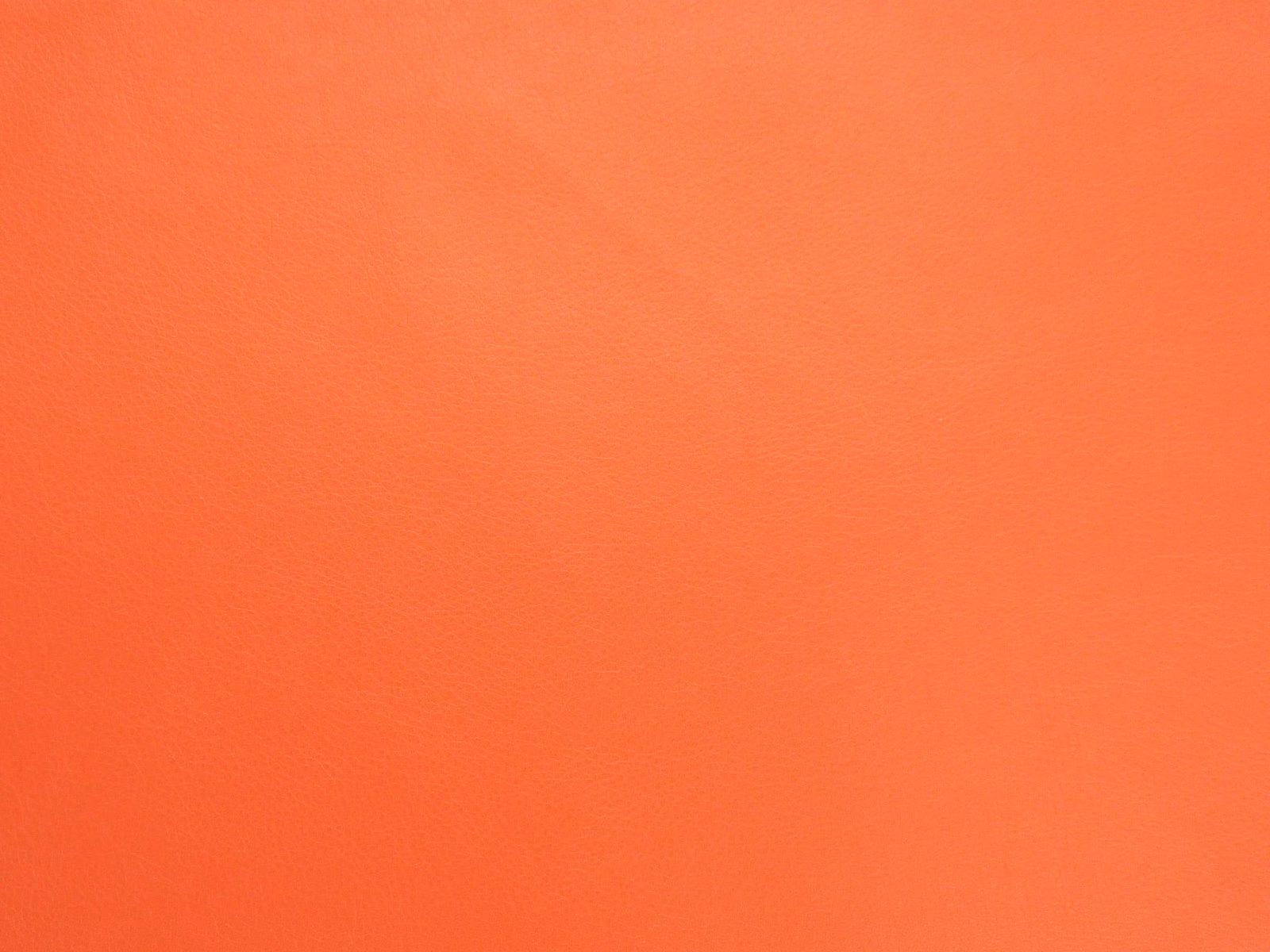 Vivid warm orange faux leather with a smooth, finely grained plain surface