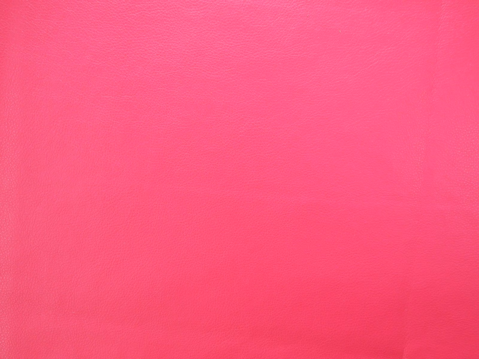 Vivid hot pink faux leather with a fine grain and subtle polished sheen