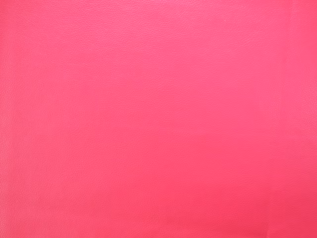 Vivid hot pink faux leather with a fine grain and subtle polished sheen