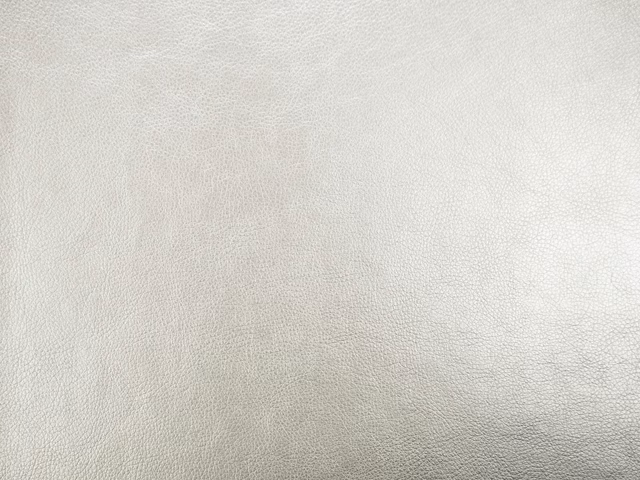 Pale ivory faux leather with a fine, softly pebbled grain and subtle grey shading