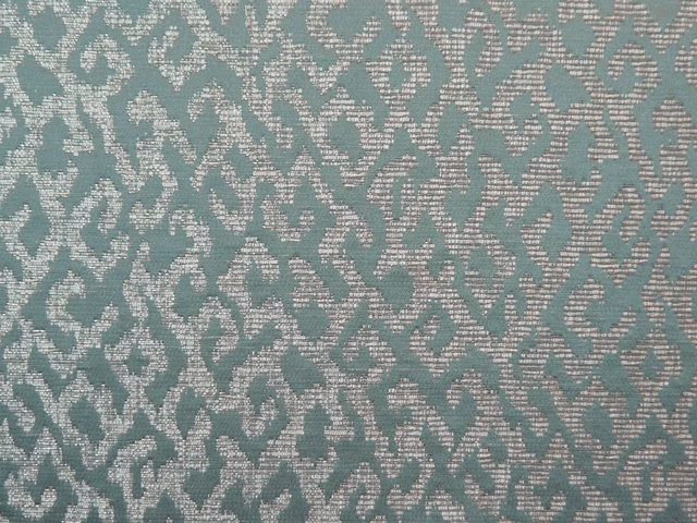 Teal chenille with pale ivory scrolling motifs and a softly nubby woven surface