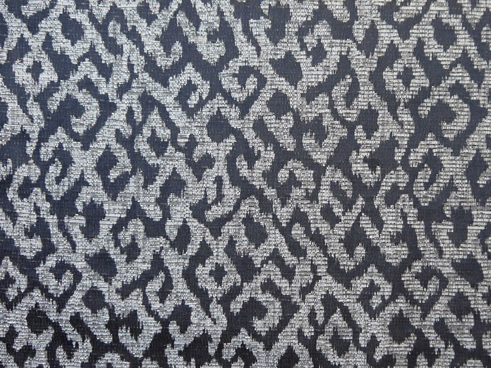 Charcoal and silver-grey chenille with a dense irregular woven motif
