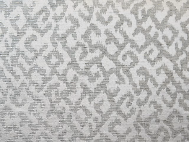Silver-grey chenille with chalk-white organic scroll motifs and a fine ribbed texture