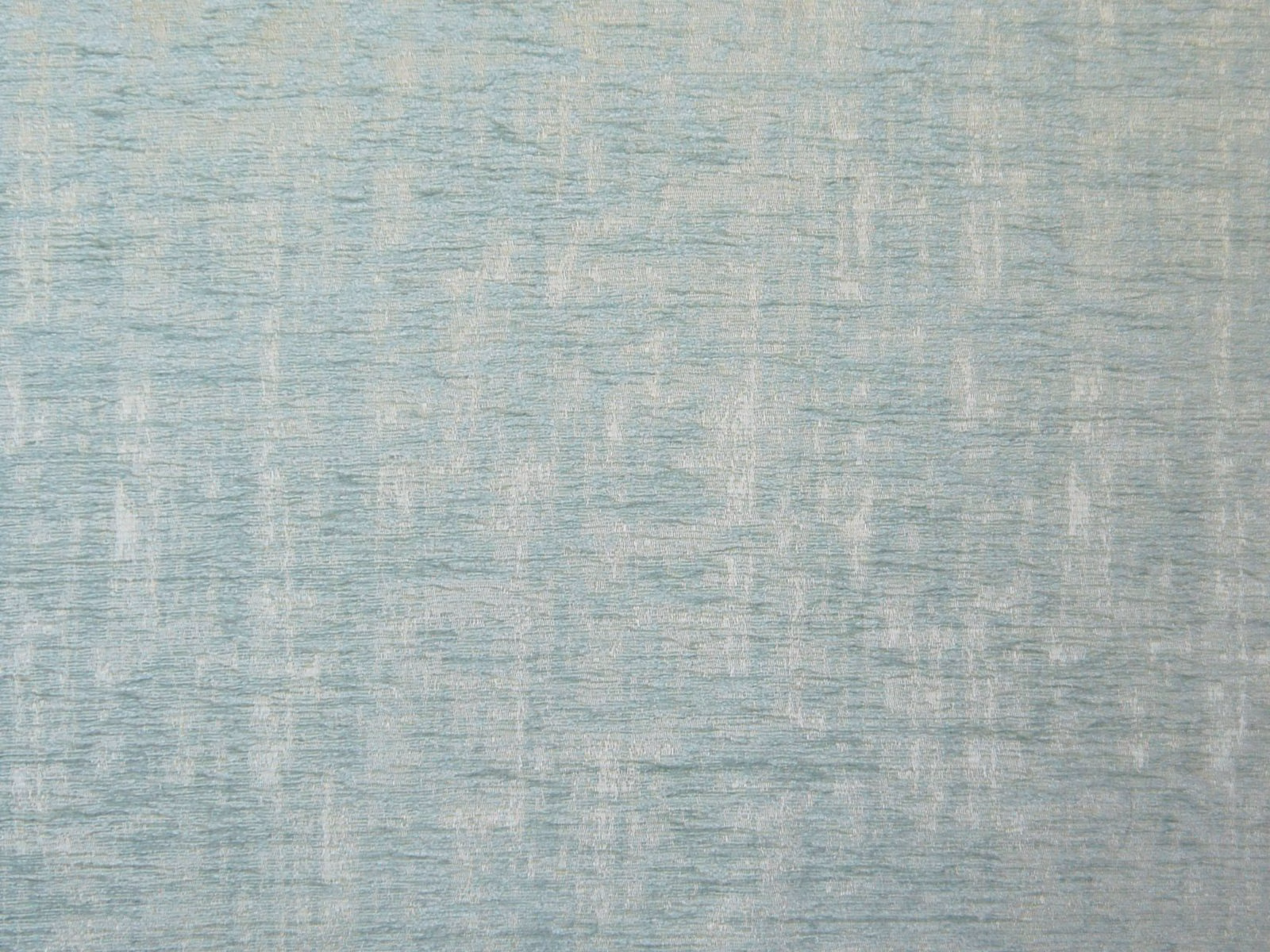 Pale blue-grey chenille with broken vertical striations and a softly mottled surface