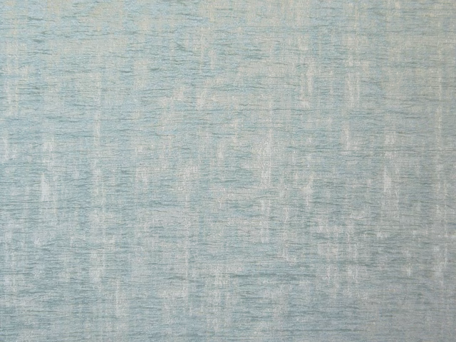 Pale blue-grey chenille with broken vertical striations and a softly mottled surface