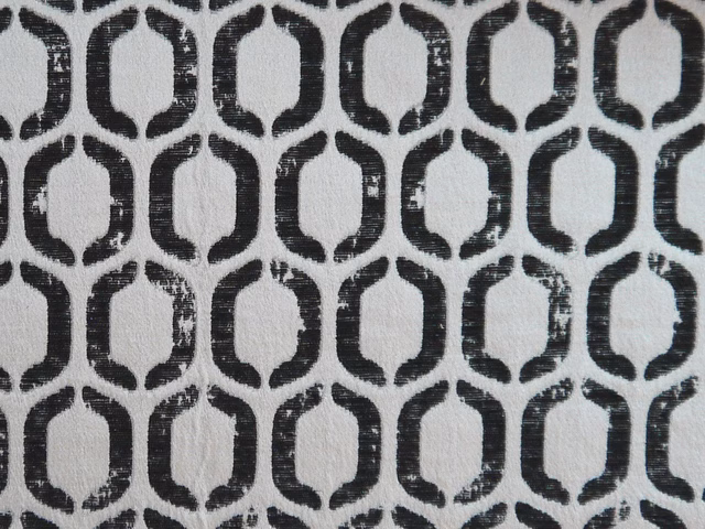 Charcoal rounded lattice pattern on a softly textured pale grey chenille ground