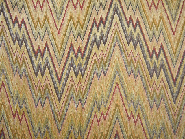 Muted olive chenille with ochre, burgundy and charcoal repeating zigzag weave