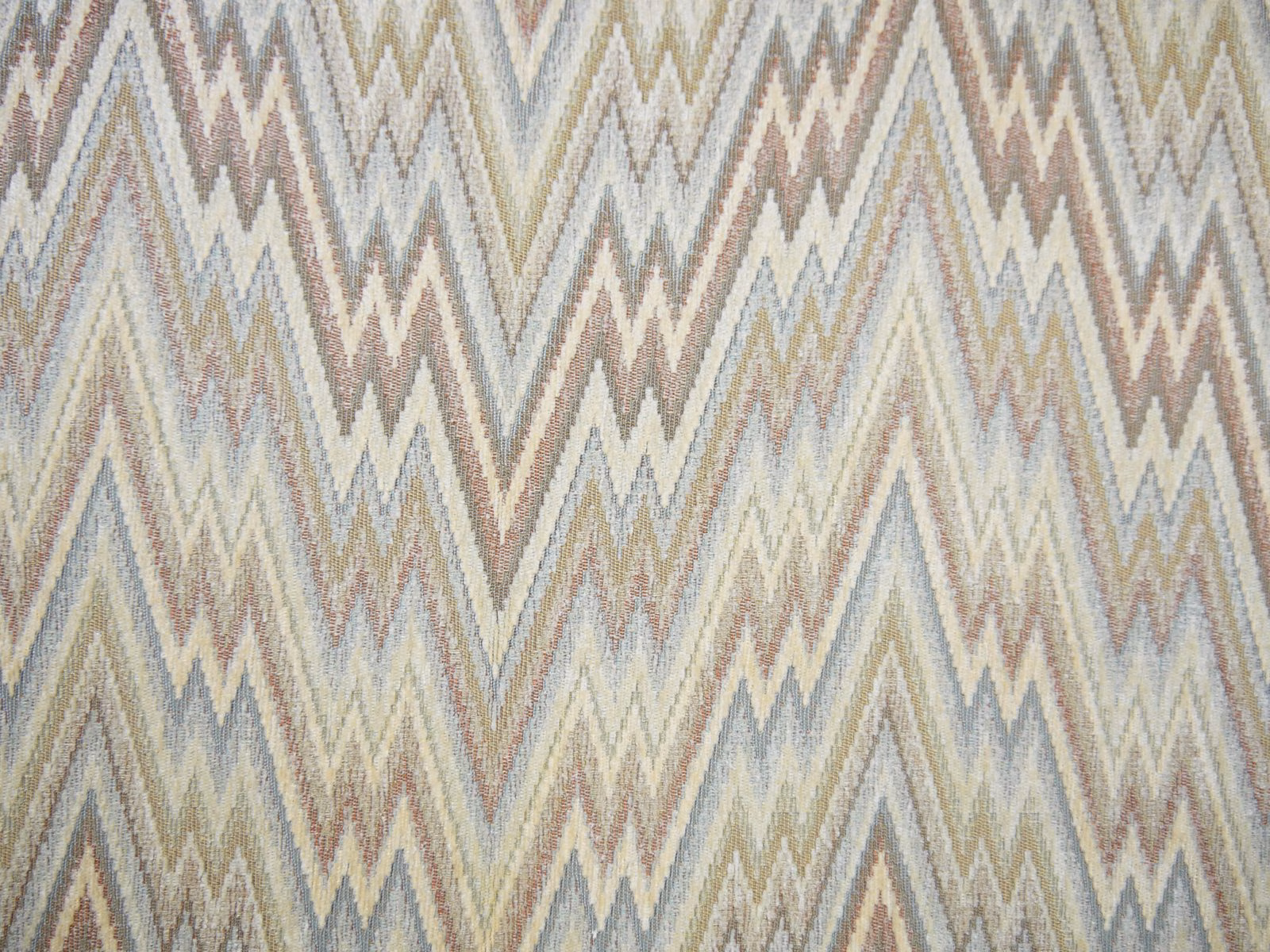 Muted chenille upholstery with cream, blue-grey, taupe and olive zigzag chevrons