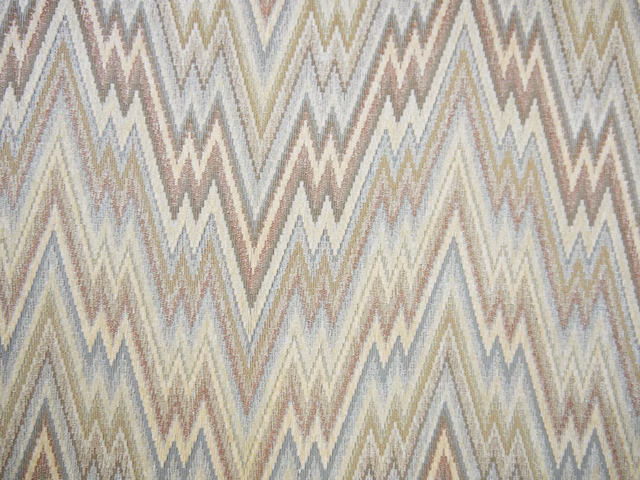 Muted chenille upholstery with cream, blue-grey, taupe and olive zigzag chevrons