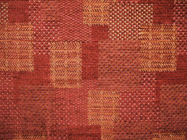 Deep red chenille with ochre chevrons and patchwork geometric blocks
