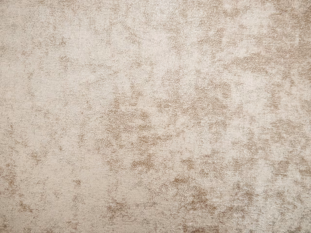 Warm ivory-beige chenille with softly brushed taupe mottling and weathered texture