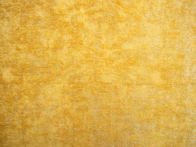 Golden ochre chenille swatch with softly mottled amber texture and gentle surface sheen
