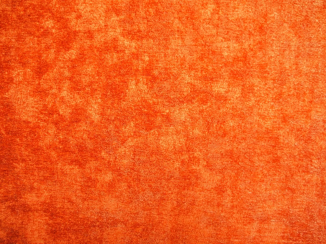 Burnt coral orange chenille with mottled rust shading and softly brushed texture