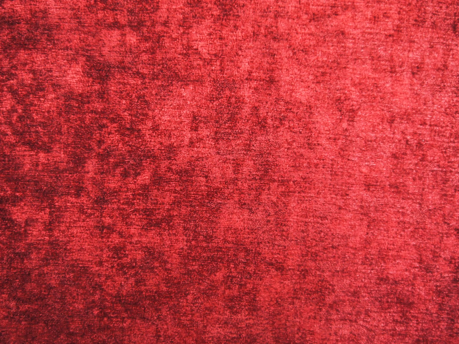 Mottled deep crimson red chenille with darker garnet flecks and soft textured shading