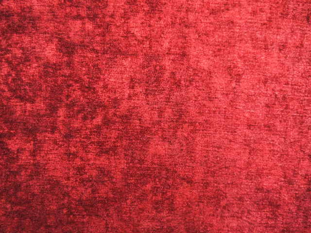 Mottled deep crimson red chenille with darker garnet flecks and soft textured shading