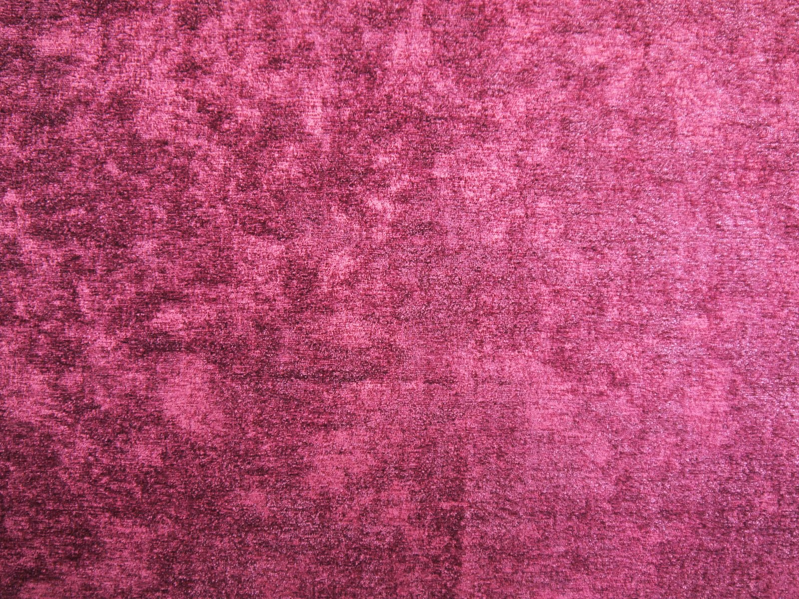 Deep raspberry-pink chenille with mottled plum shading and a softly brushed texture