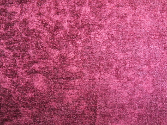 Deep raspberry-pink chenille with mottled plum shading and a softly brushed texture
