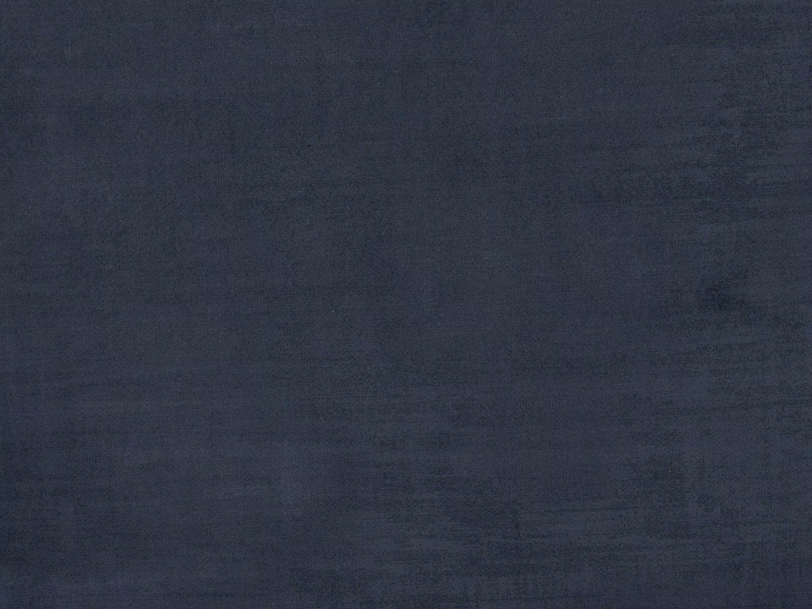 Close-up of dark charcoal-blue velvet with soft brushed tonal texture