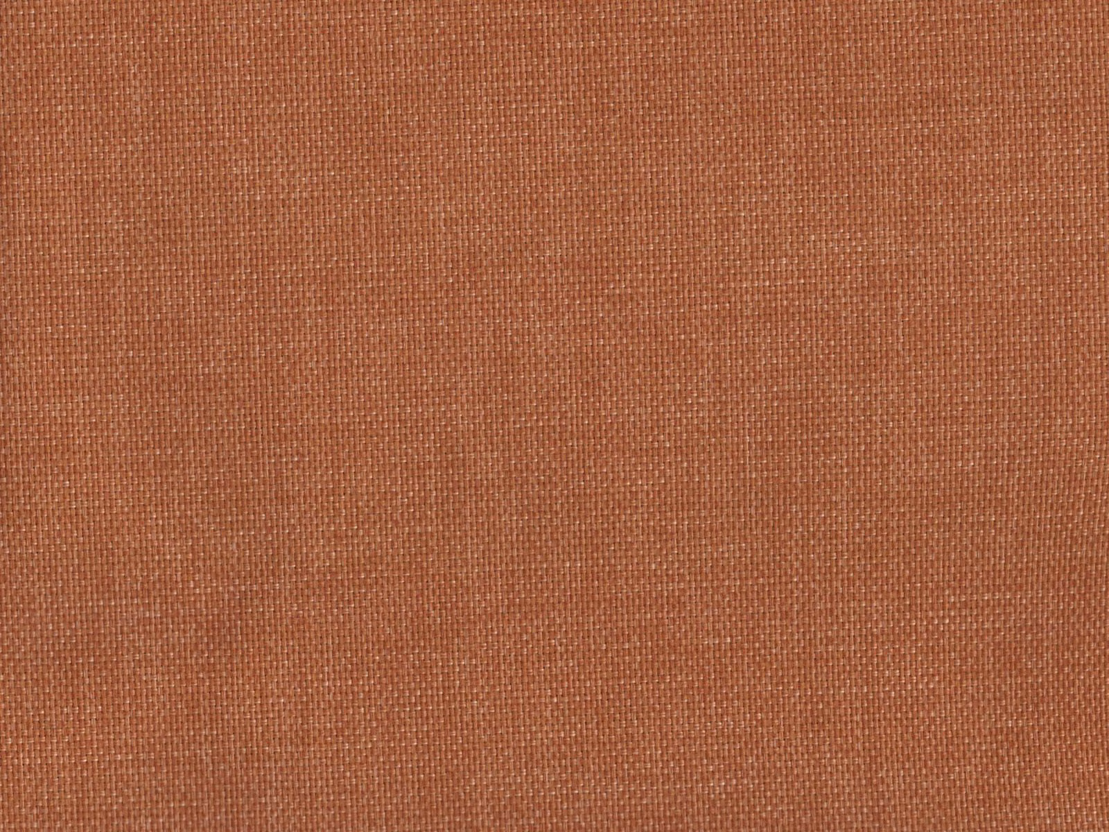 Close-up of muted terracotta rust flat-weave fabric with a fine woven grid