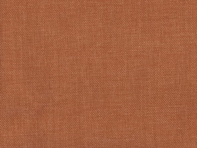 Close-up of muted terracotta rust flat-weave fabric with a fine woven grid
