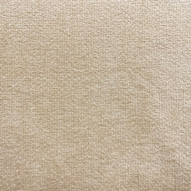 Close-up of warm oatmeal chenille with a softly mottled woven surface