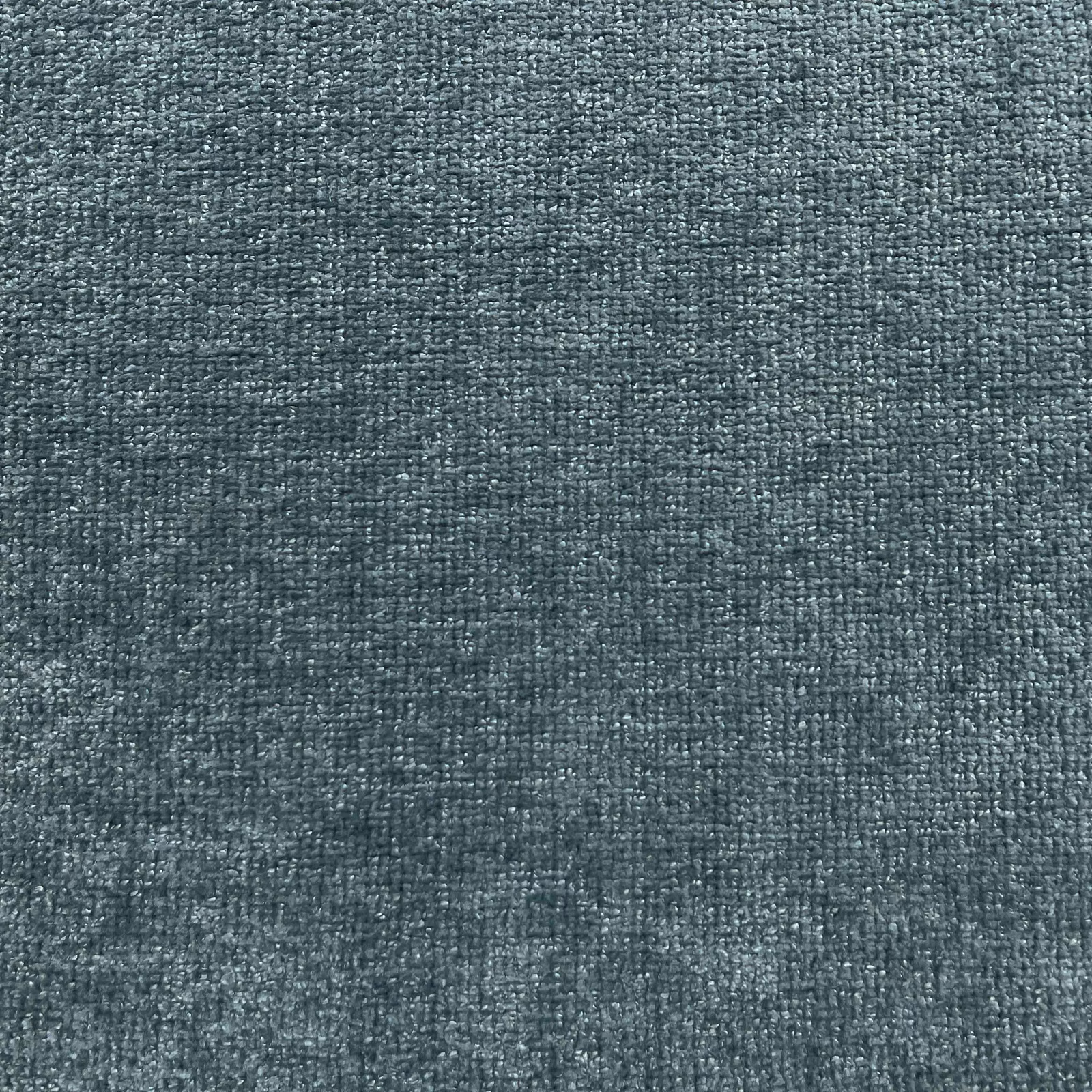 Close-up of deep blue-grey chenille with a dense, softly flecked woven texture