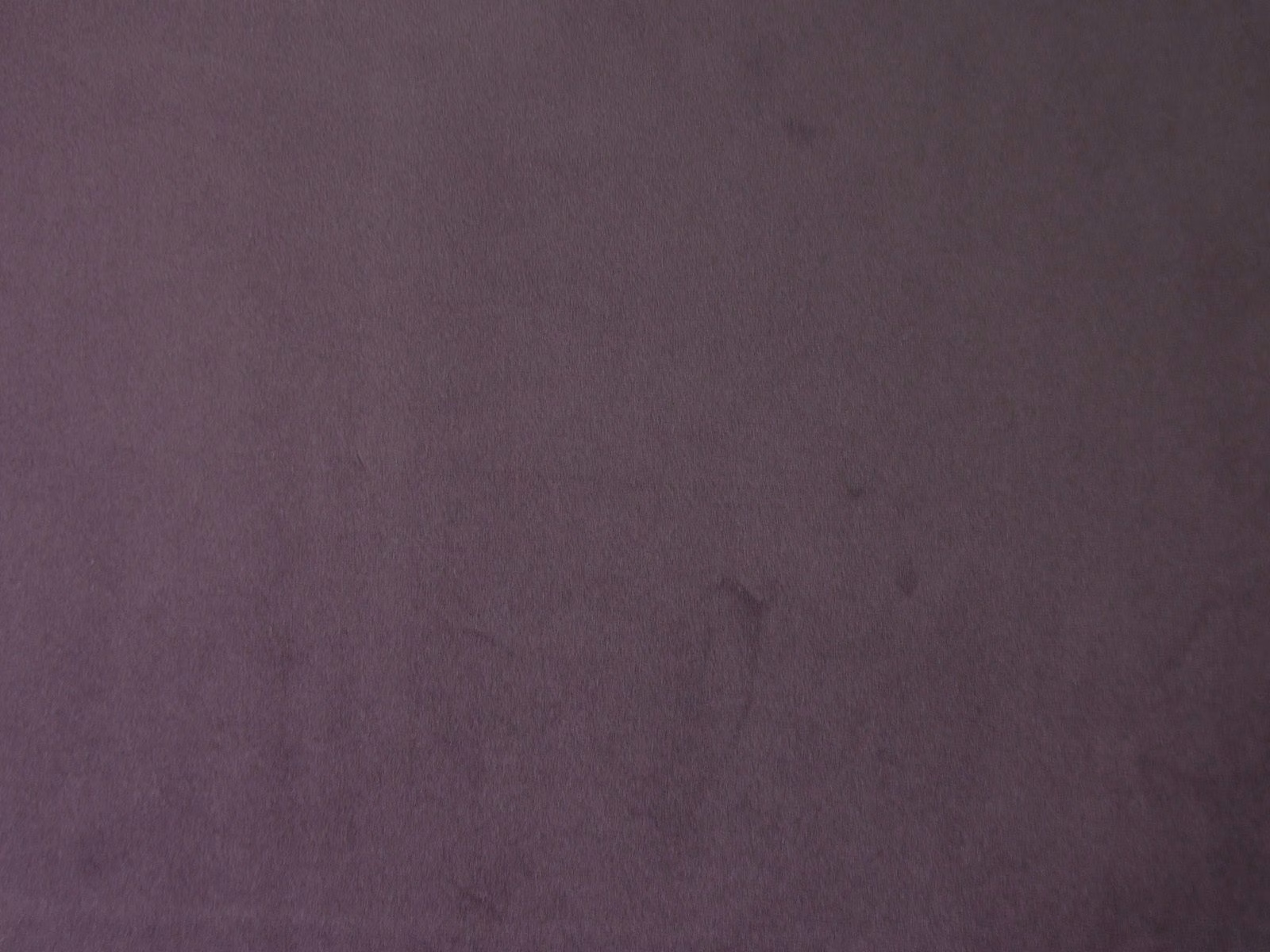 Deep muted plum-purple velvet showing a soft, subtly directional pile