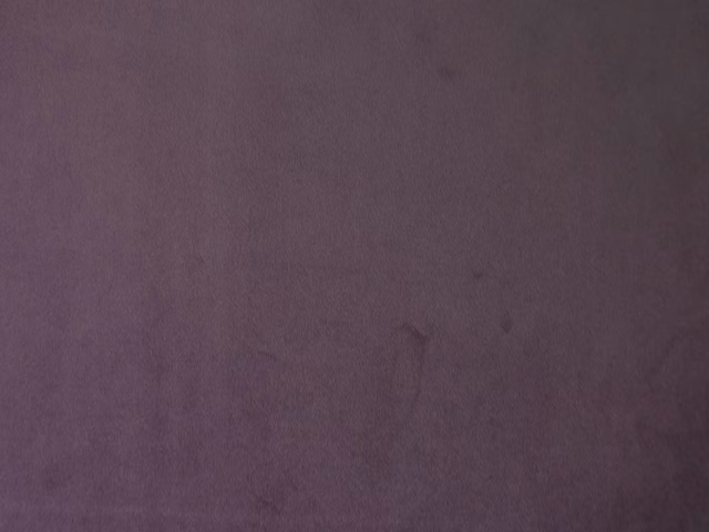 Deep muted plum-purple velvet showing a soft, subtly directional pile