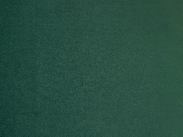 Deep forest-green velvet swatch showing soft nap and subtle tonal light variation