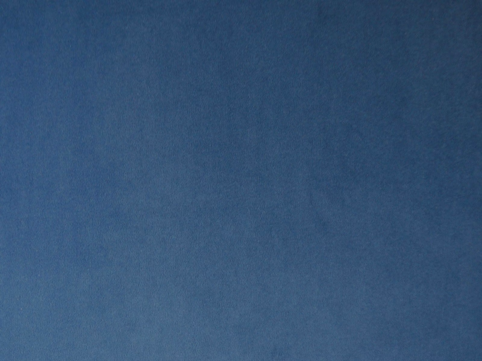 Deep slate-blue velvet swatch with soft directional nap and subtle tonal shading