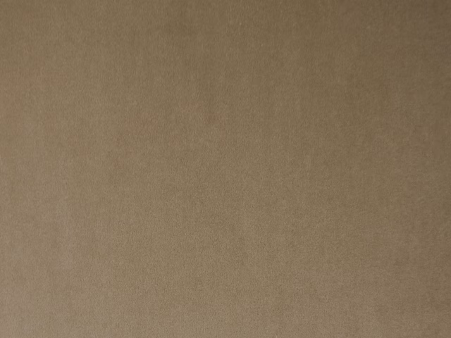 Warm mushroom-taupe velvet with a softly brushed, subtly varied surface