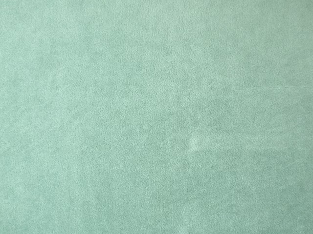 Pale mint-teal velvet with a softly mottled nap and plain surface