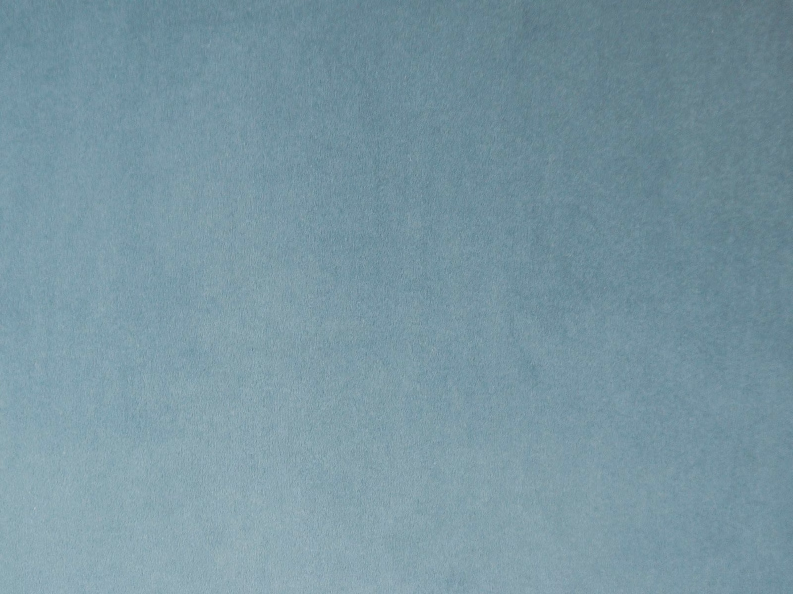Soft aqua-blue velvet with a subtly mottled nap catching the light