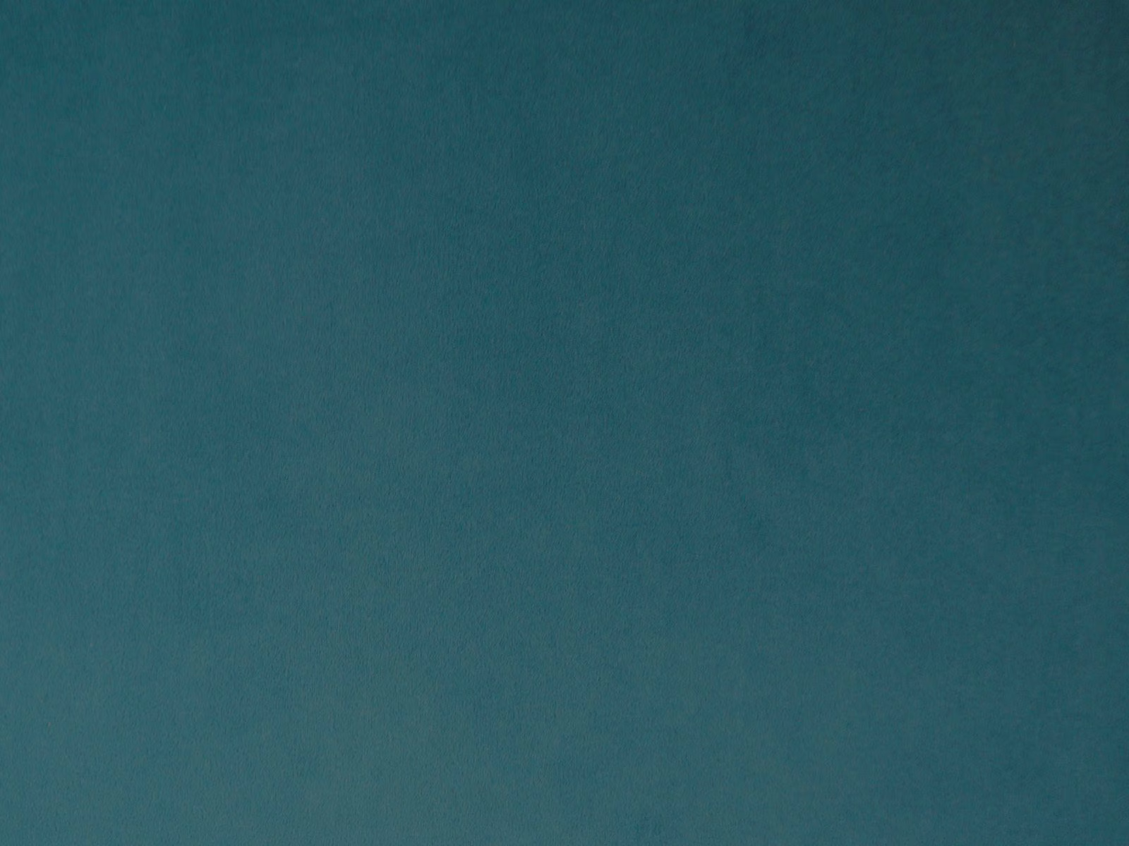 Deep blue-teal velvet with a softly mottled short pile catching the light