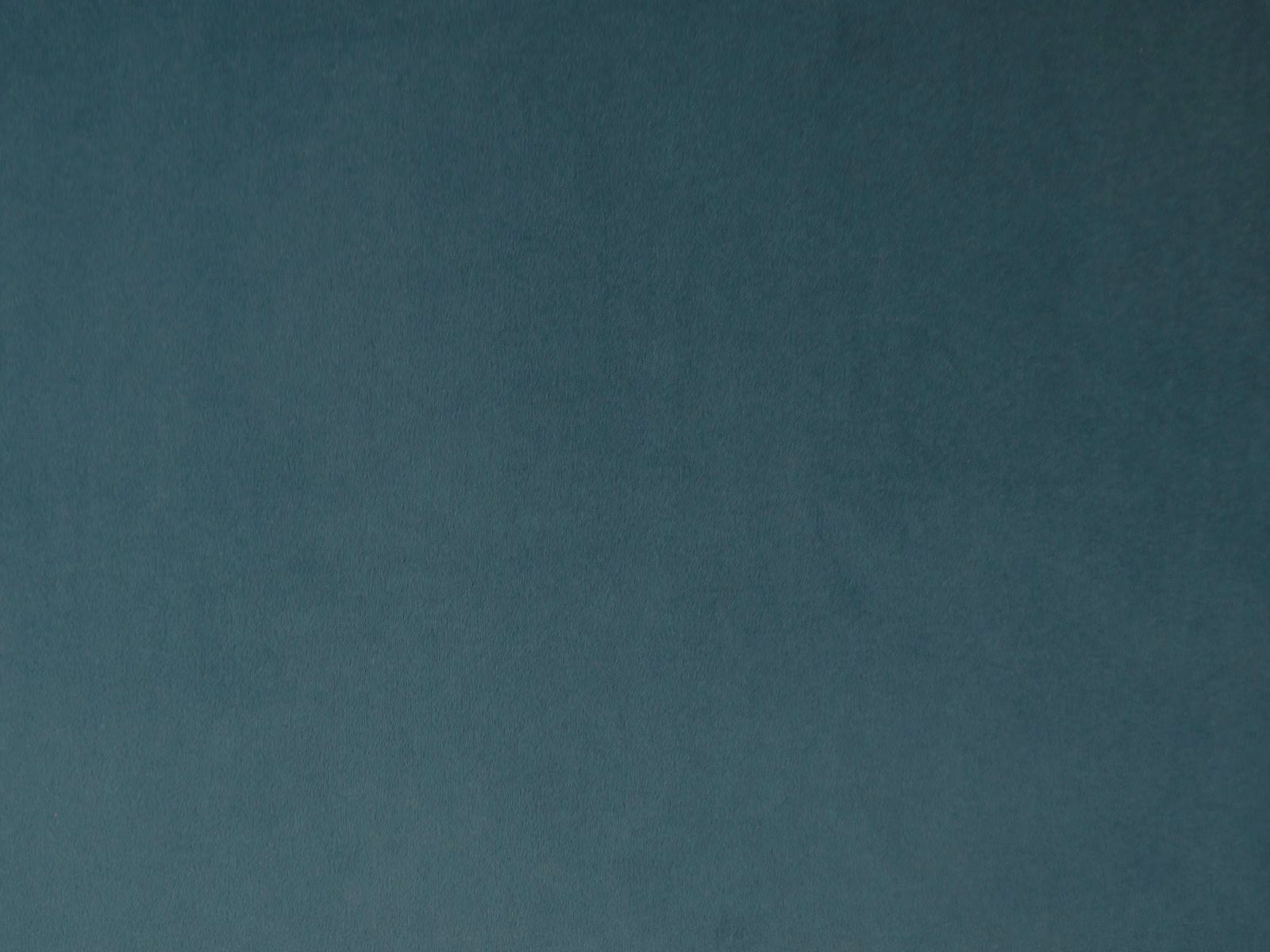 Deep blue-green teal velvet with subtle nap shading across a plain surface