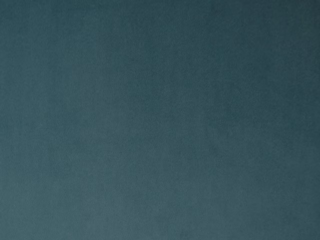 Deep blue-green teal velvet with subtle nap shading across a plain surface