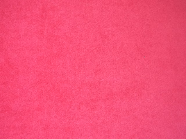 Vivid fuchsia pink velvet swatch showing a soft, subtly directional plush pile